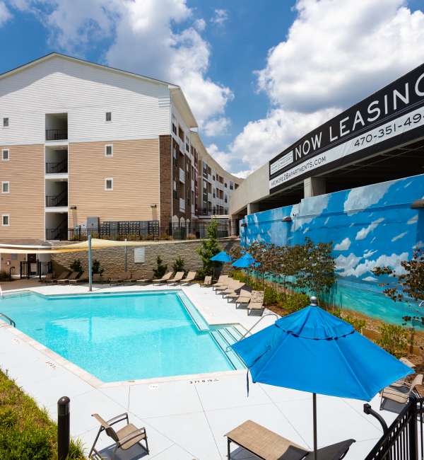 Swimming pool with lounge chairs and umbrellas at Ardmore & Twenty Eighth in Atlanta, Georgia
