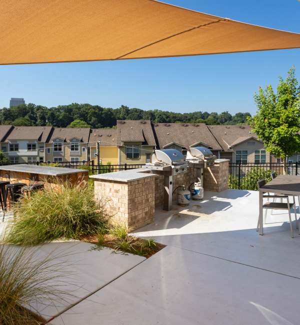 Grill station with seating area and greenery at Ardmore & Twenty Eighth in Atlanta, Georgia