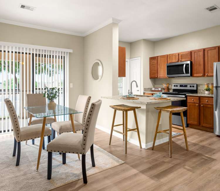 Dining room and view of kitchen at Villas at Medical Center in San Antonio, Texas