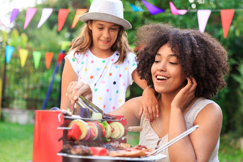 A resident and her daughter using the outdoor grilling area at Quill in Atlanta, Georgia