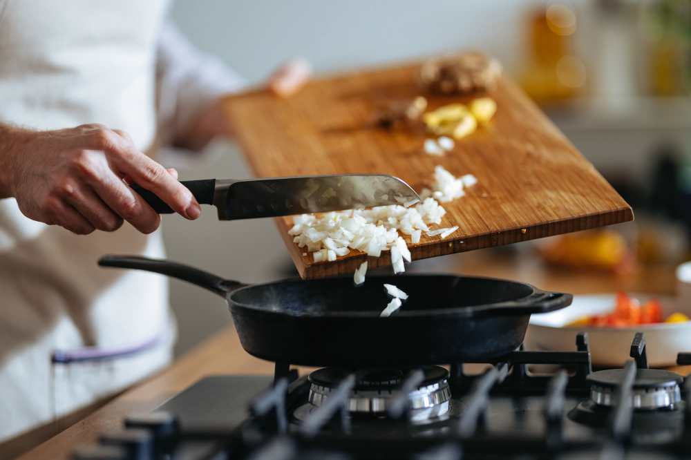 Chef chopping onions in modern kitchen at The Residences at Talcott in Weatogue, Connecticut