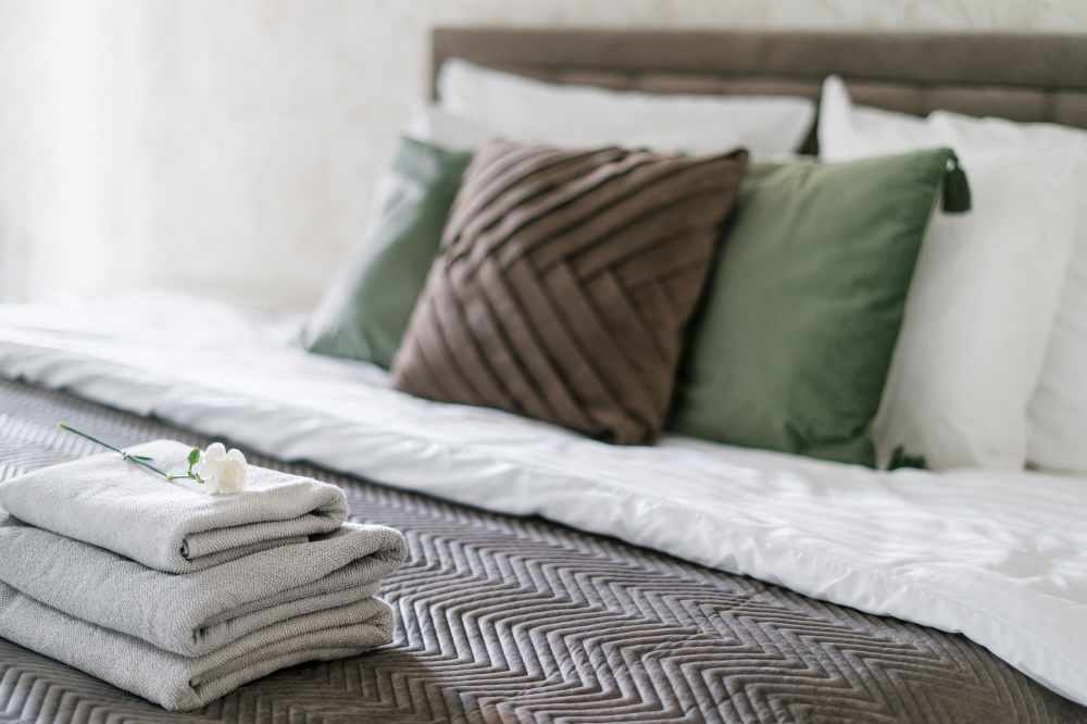 Stylish bedroom with fresh linens and decor at The Residences at Talcott in Weatogue, Connecticut