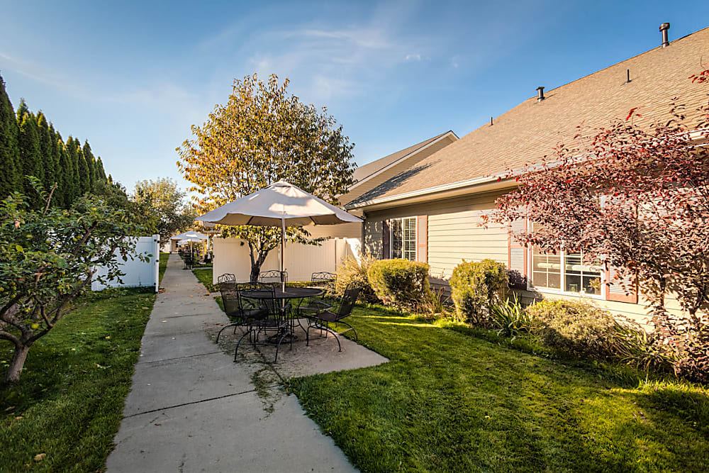 Sidewalk leading to beautiful grounds at Pacifica Senior Living Coeur d'Alene in Coeur d'Alene, Idaho