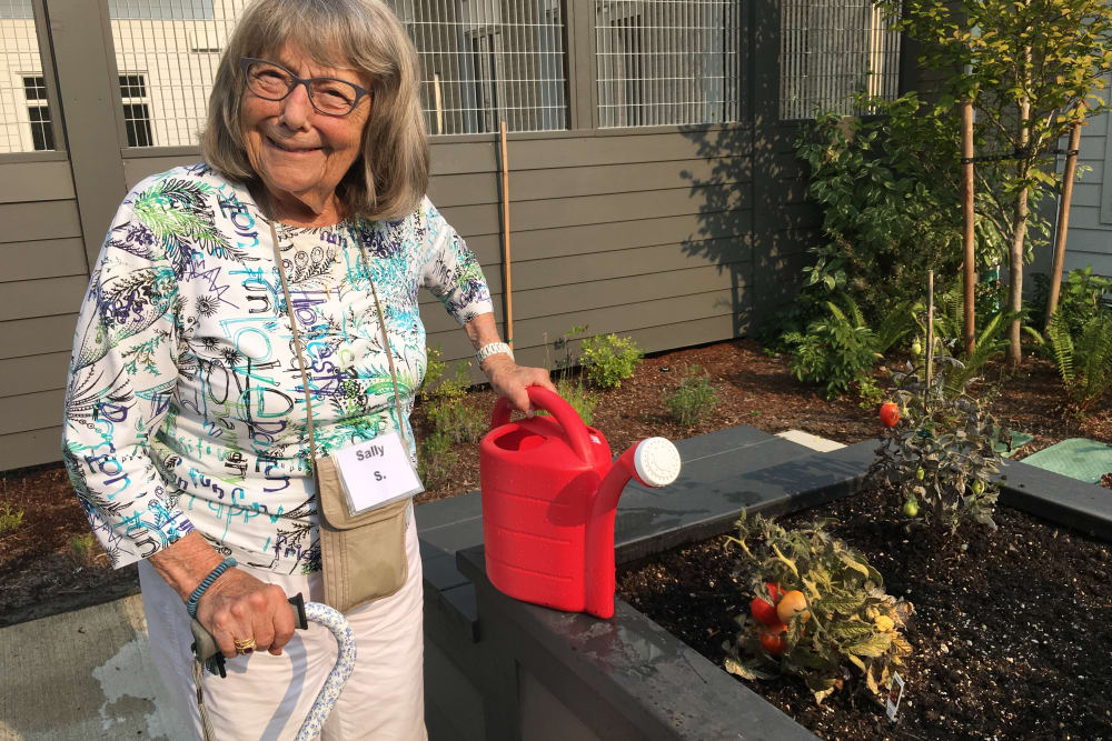 Resident gardening at Merrill Gardens at Burien in Burien, Washington. 