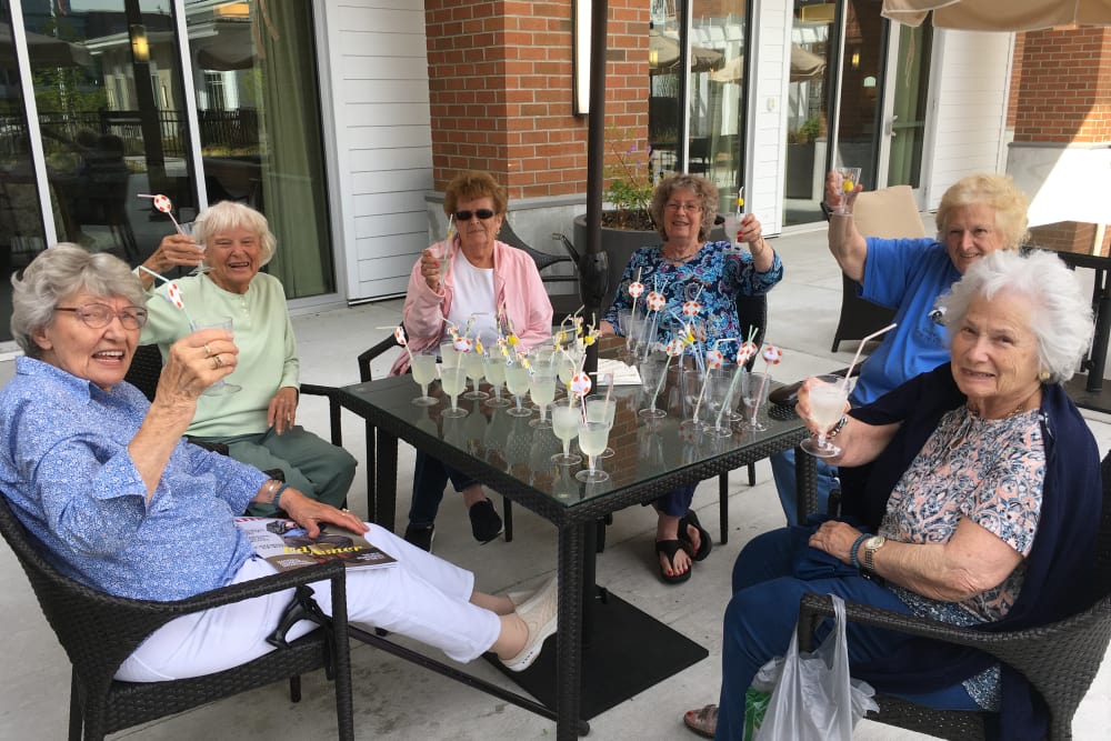 Residents sitting outside near Merrill Gardens at Burien in Burien, Washington. 