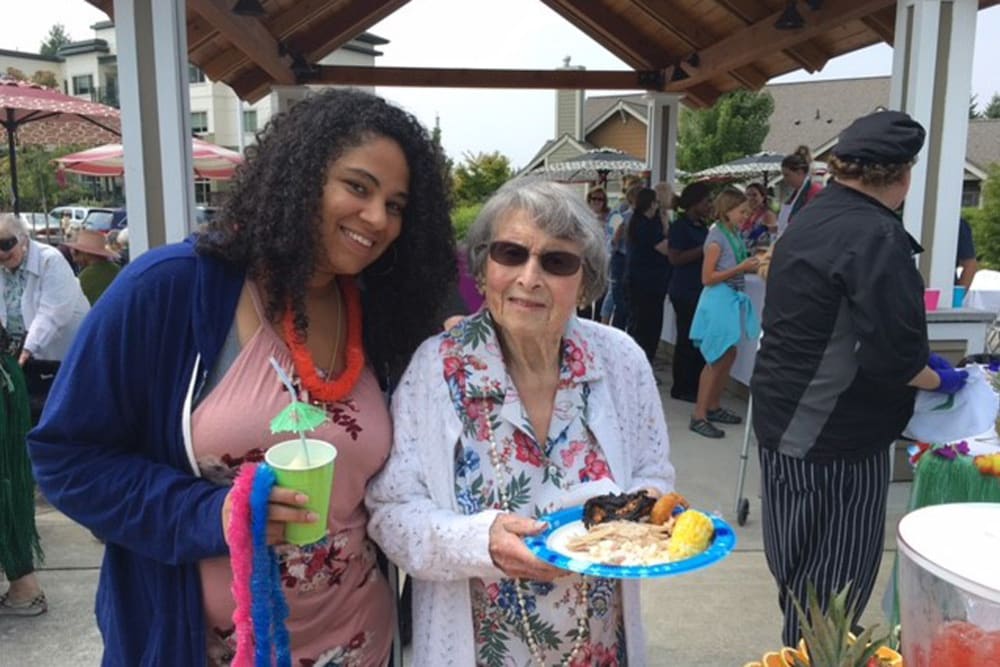 A resident and staff member getting food at Merrill Gardens at Tacoma in Tacoma, Washington. 