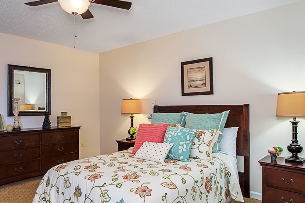 Bedroom model with blue accents at Grand Villa of Englewood in Florida