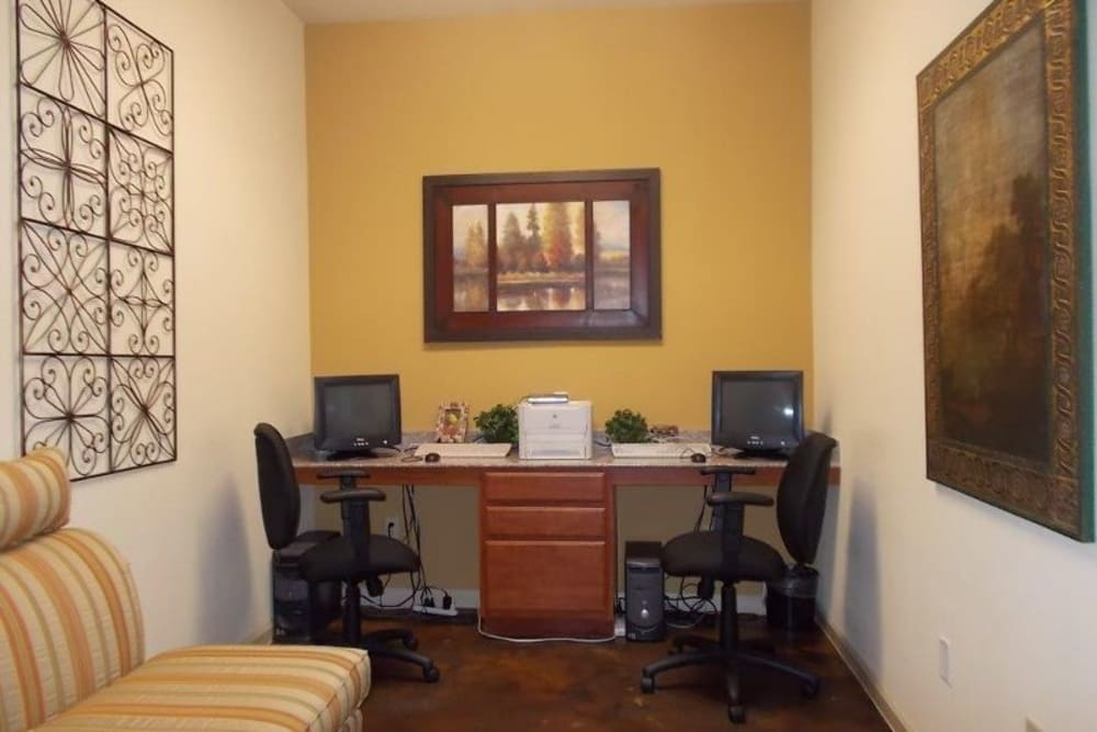 A business center with complimentary computers at Woodside Manor in Conroe, Texas