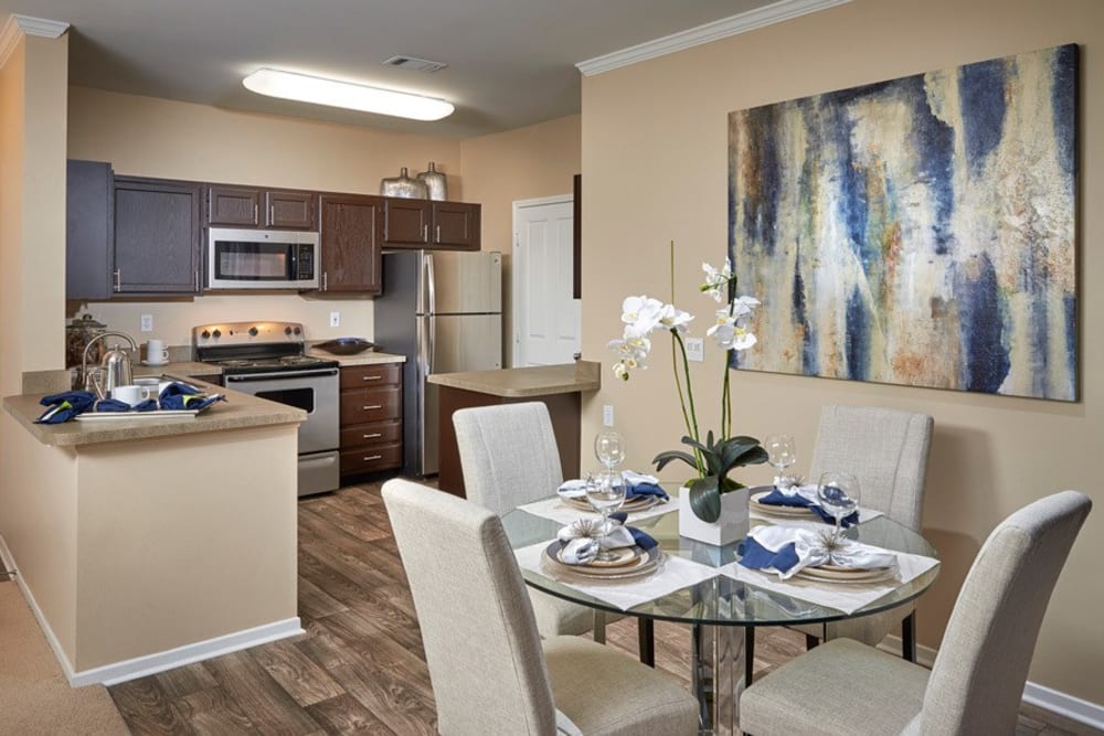 Kitchen with wood-style flooring at Legend Oaks Apartments in Aurora, Colorado