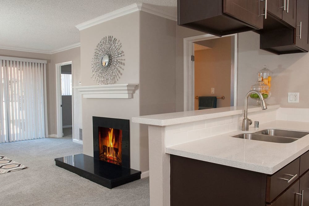 Living room with a fireplace at La Valencia Apartment Homes in Campbell, California