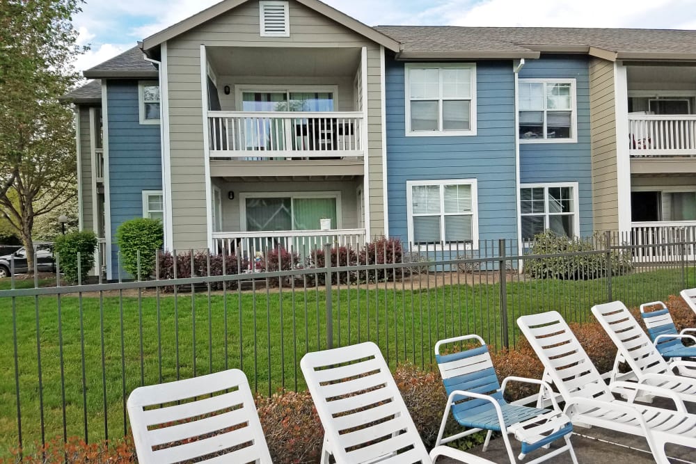 Poolside Lounge Chairs & Exterior of Tualatin View Apartments in Portland, OR