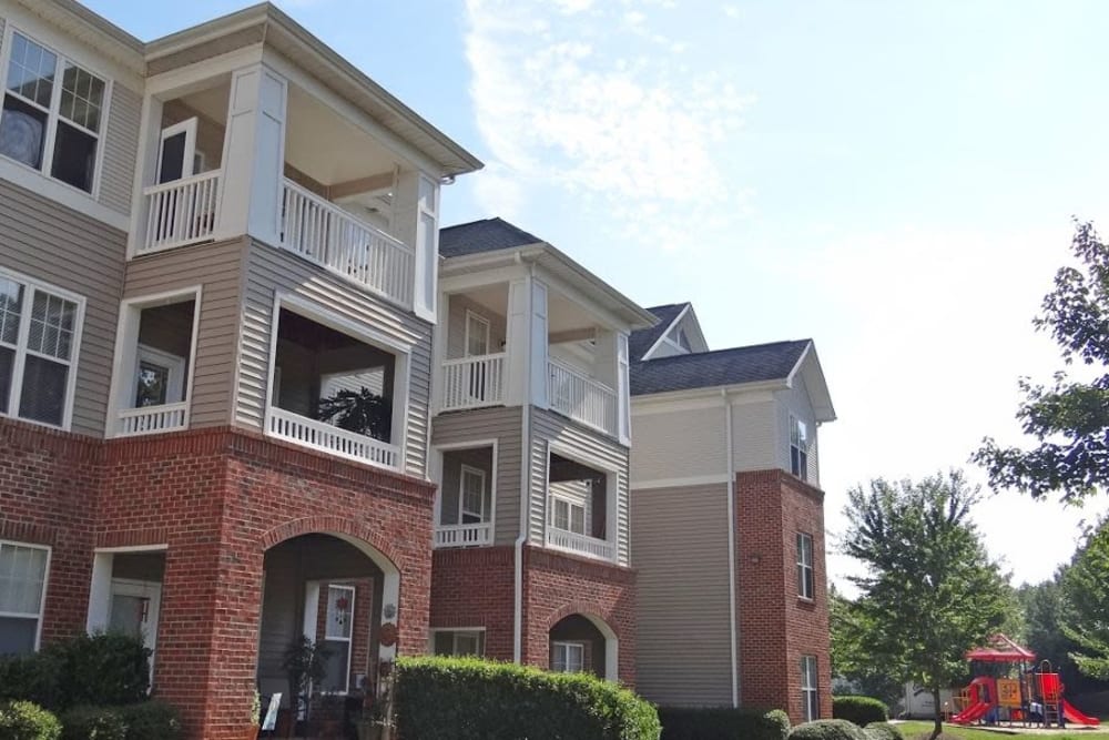 Beautiful apartment building with private balconies at Heather Park Apartment Homes in Garner, NC