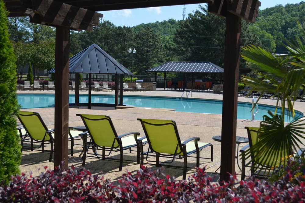 Poolside pergola with lounge chairs at The Abbey at Inverness in Birmingham, Alabama