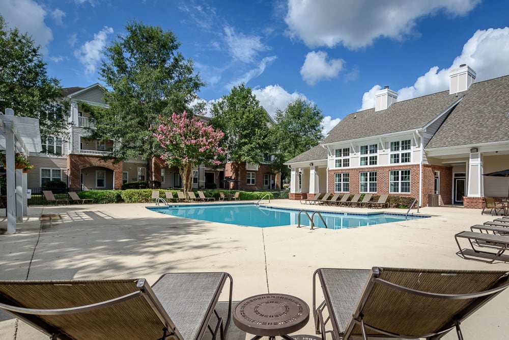 Sparkling swimming pool with lounge seating at Falls Creek Apartments & Townhomes in Raleigh, NC