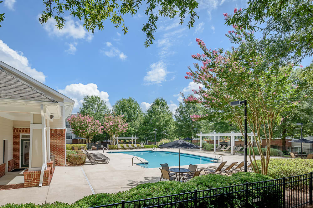 Pool and clubhouse at Falls Creek Apartments & Townhomes in Raleigh, NC