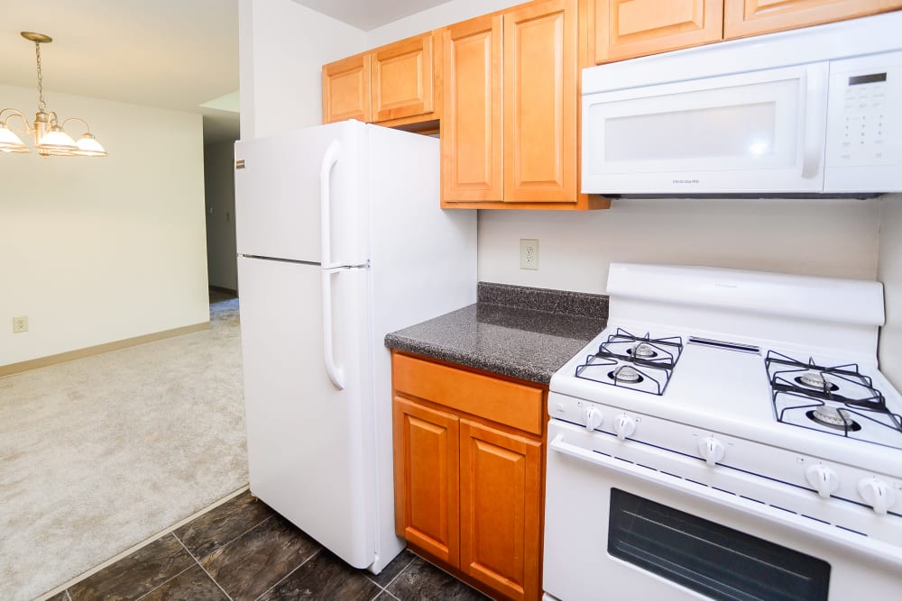 Modern kitchen with white appliances at Cranbury Crossing Apartment Homes in East Brunswick, New Jersey