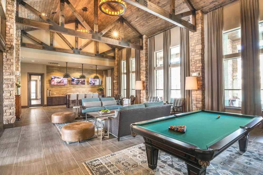 Shuffleboard in resident lounge at The Abbey at Spring Town Center in Spring, Texas
