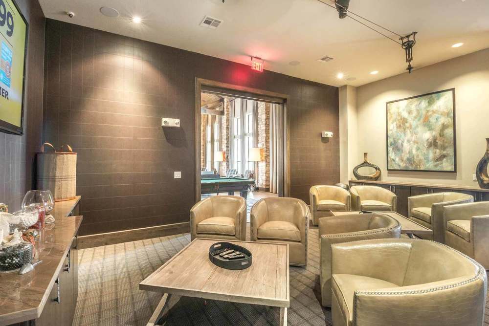 Movie theater with seats with cupholders for beverages and snacks at The Abbey at Spring Town Center in Spring, Texas