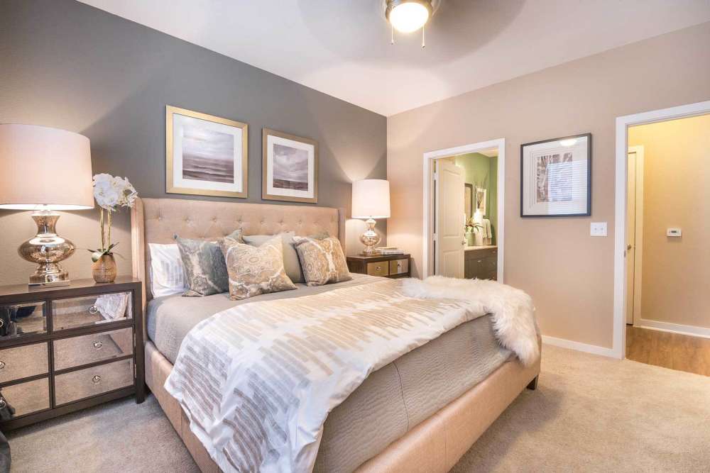 Well-lit bedroom with large comfortable bed and ambient lighting at The Abbey at Spring Town Center in Spring, Texas