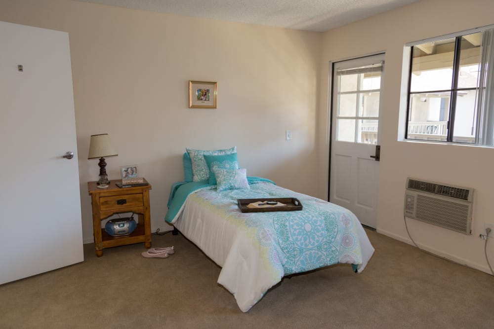 Pre-renovated bedroom at Del Obispo Terrace Senior Living in San Juan Capistrano, CA