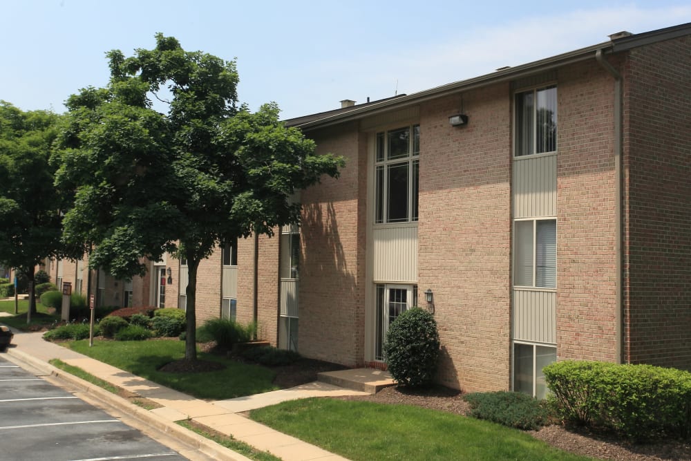 Brick building exterior and sidewalk at Quail Hollow Apartment Homes in Glen Burnie, Maryland
