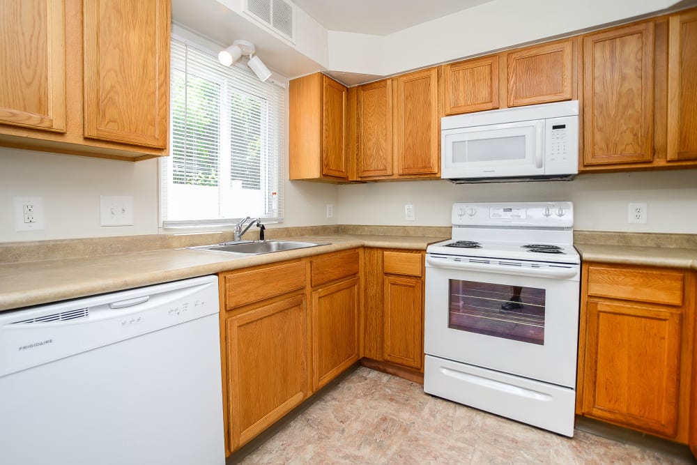 Kitchen with oak cabinets and white appliances at Seagrass Cove Apartment Homes in Pleasantville, New Jersey