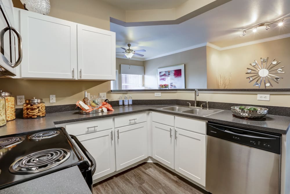 Kitchen with white cabinets and stainless-steel appliances at Bella Springs Apartments in Colorado Springs, Colorado