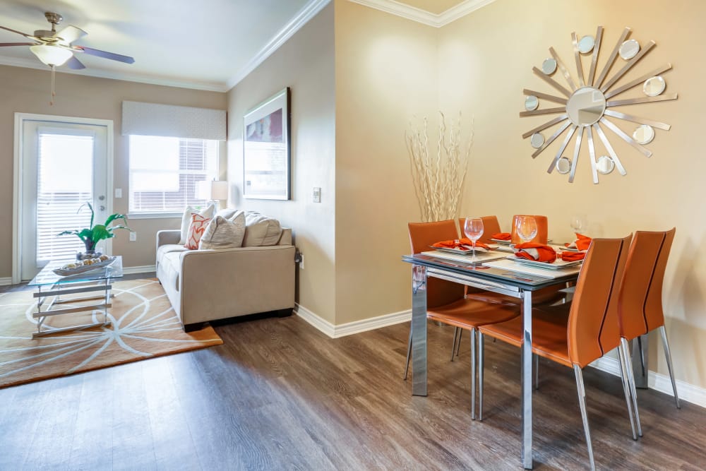 Model dining area into the living room at Bella Springs Apartments in Colorado Springs, Colorado