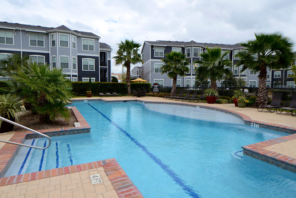 Swimming pool area at The Abbey at Grant Road in Houston, Texas