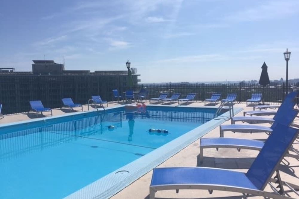 Outdoor and pool and lounge chairs at The Carlyle Apartments in Baltimore, Maryland