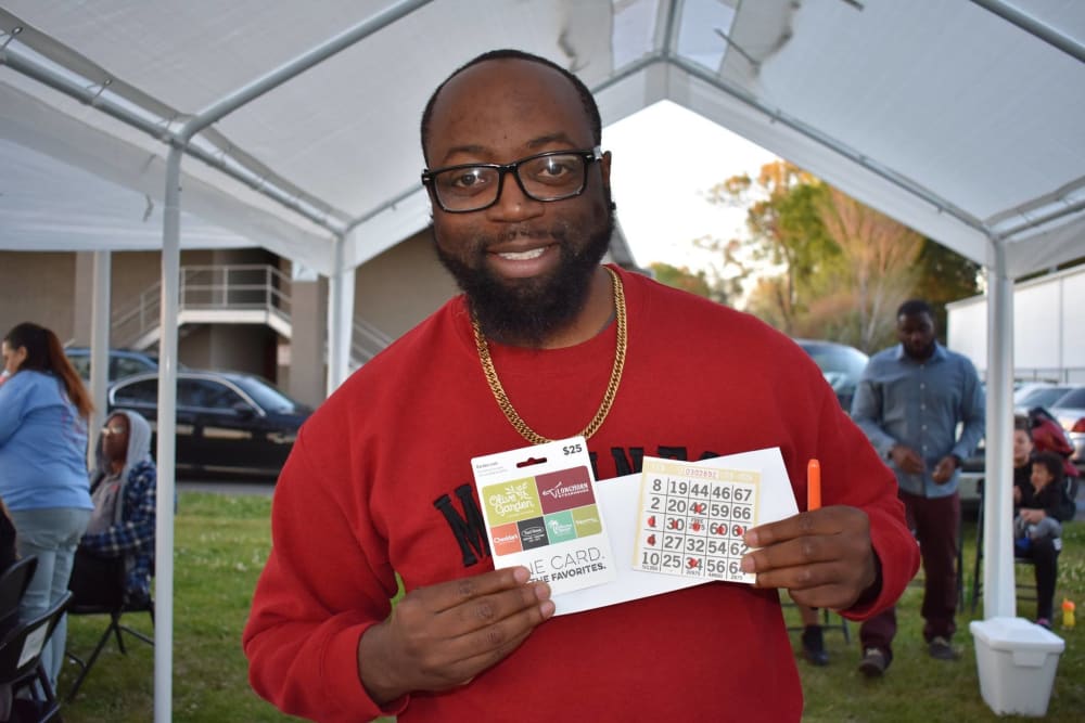 Resident with his prize from a resident event at Avalon Apartment Homes in Baton Rouge, Louisiana