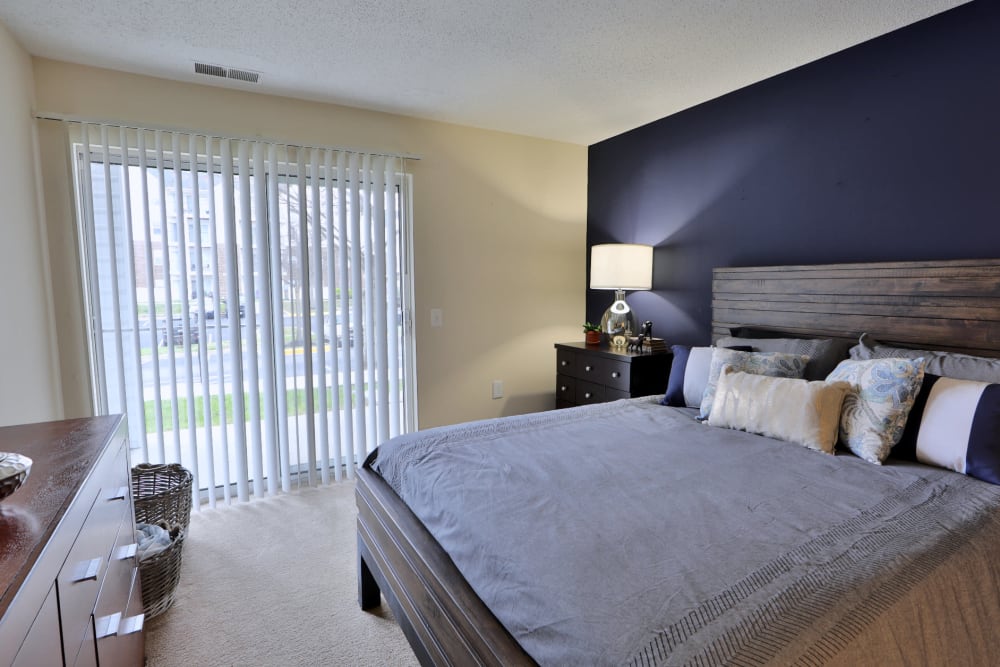 Model bedroom with side door at The Apartments at Diamond Ridge in Baltimore, Maryland
