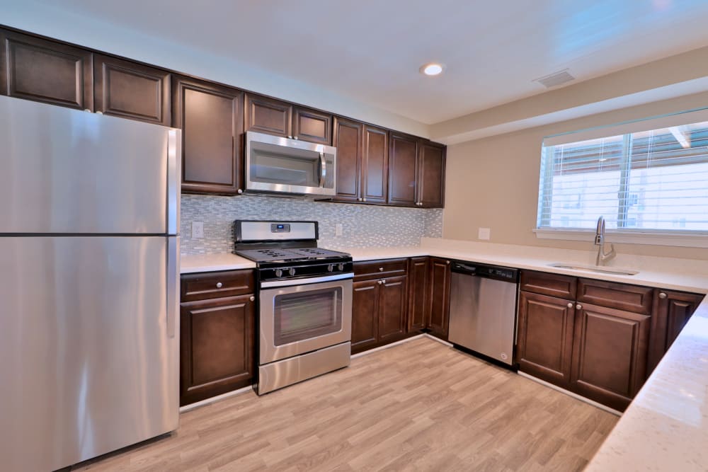 Contemporary kitchen with stainless-steel appliances at Lighthouse at Twin Lakes Apartment Homes in Beltsville, Maryland