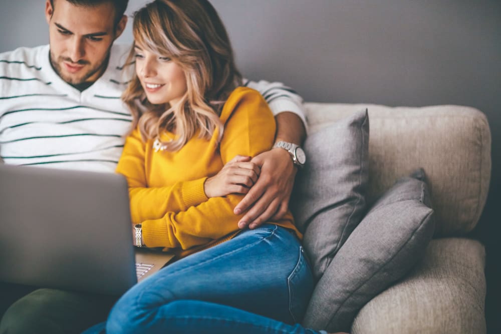 Couple browsing the web at Heatherwood Apartments in Sacramento, California