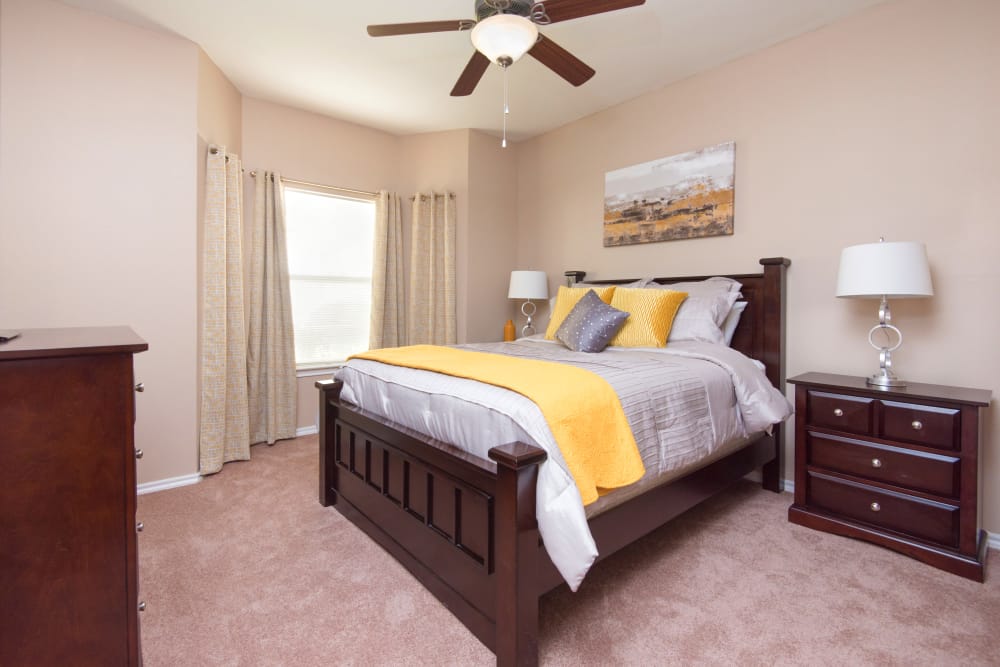 Bedroom with ceiling fan at Villas of Preston Creek