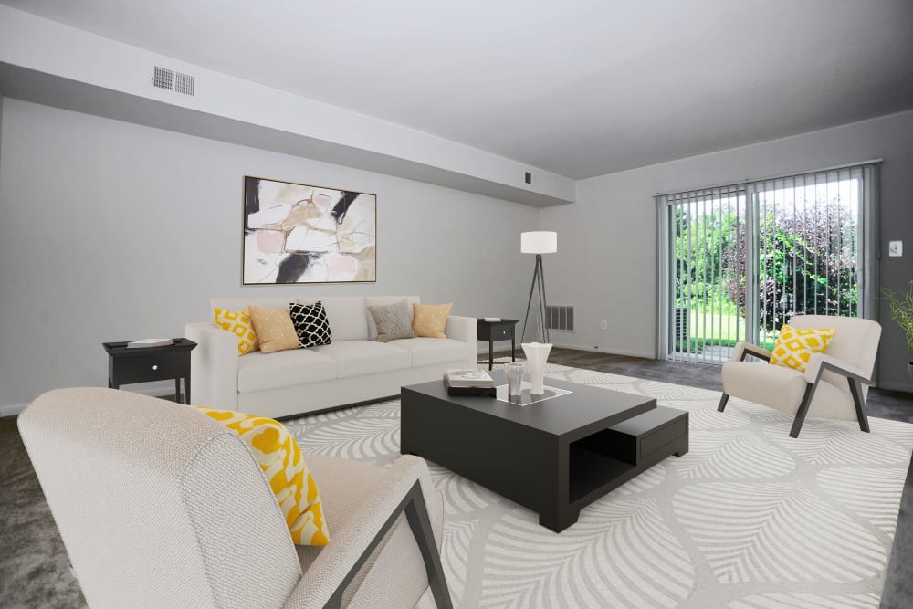Spacious living room opening onto a private patio at The Fairways Apartment Homes in Blackwood, New Jersey
