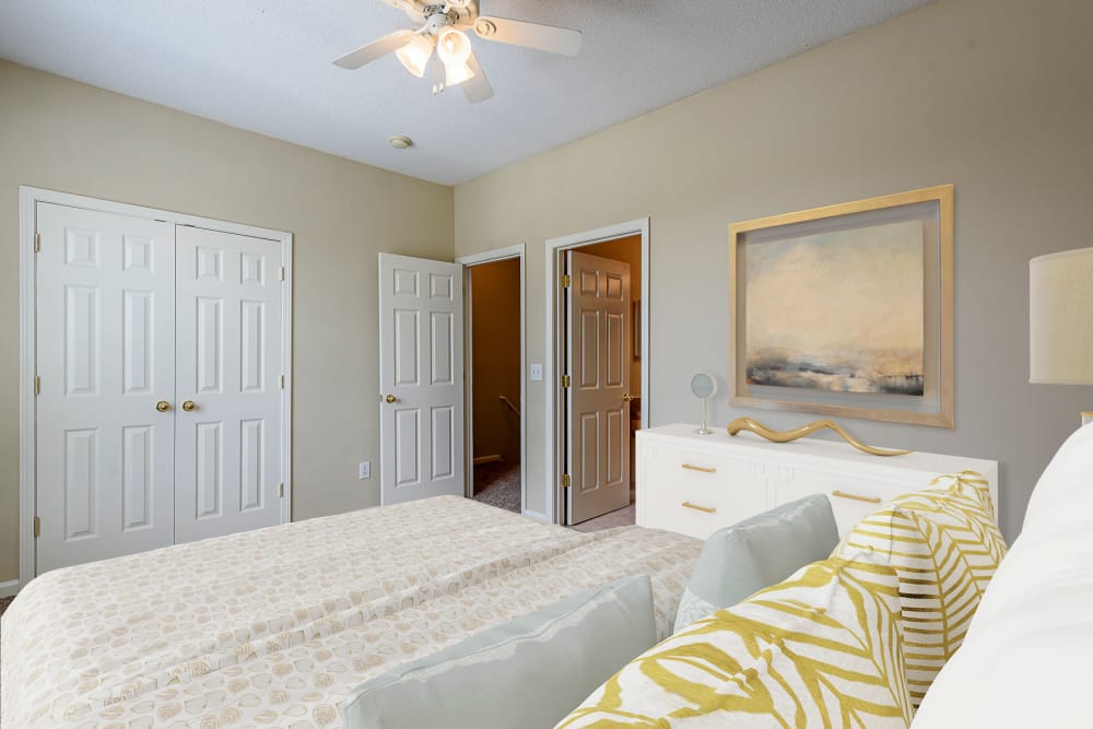Bedroom with a ceiling fan and large closet at Falls Creek Apartments & Townhomes in Raleigh, NC