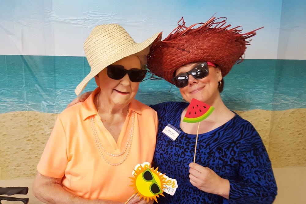 two senior women wearing fun hats at Truewood by Merrill, Henderson in Henderson, Nevada