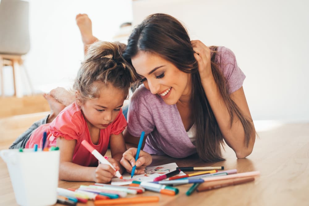 Mother teaching her daughter to draw at Augusta Woods in Sacramento, California