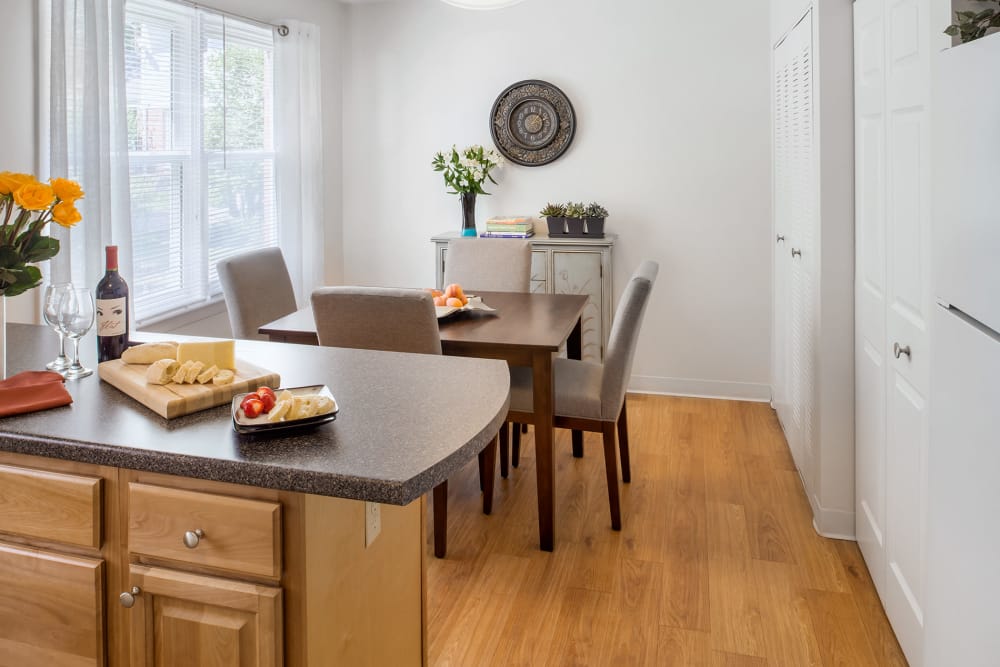 Model kitchen and dining room with wooden floors at Stony Brook Commons in Roslindale, Massachusetts