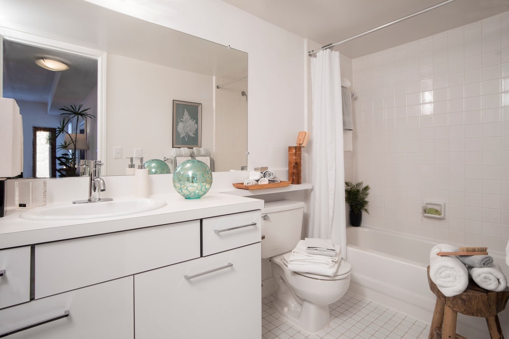 Bathroom with white cabinetry and tub/shower at Citation Club in Farmington Hills, Michigan