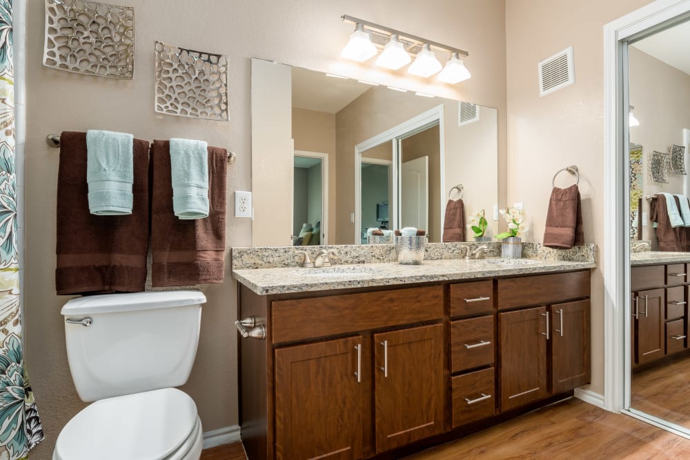 Bathroom with vanity at El Lago Apartments