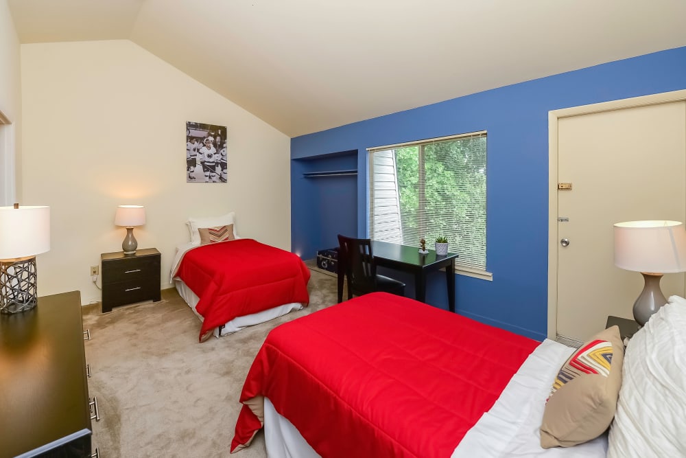 Model bedroom with two twin beds and a desk at Briarwood Apartments & Townhomes in State College, Pennsylvania