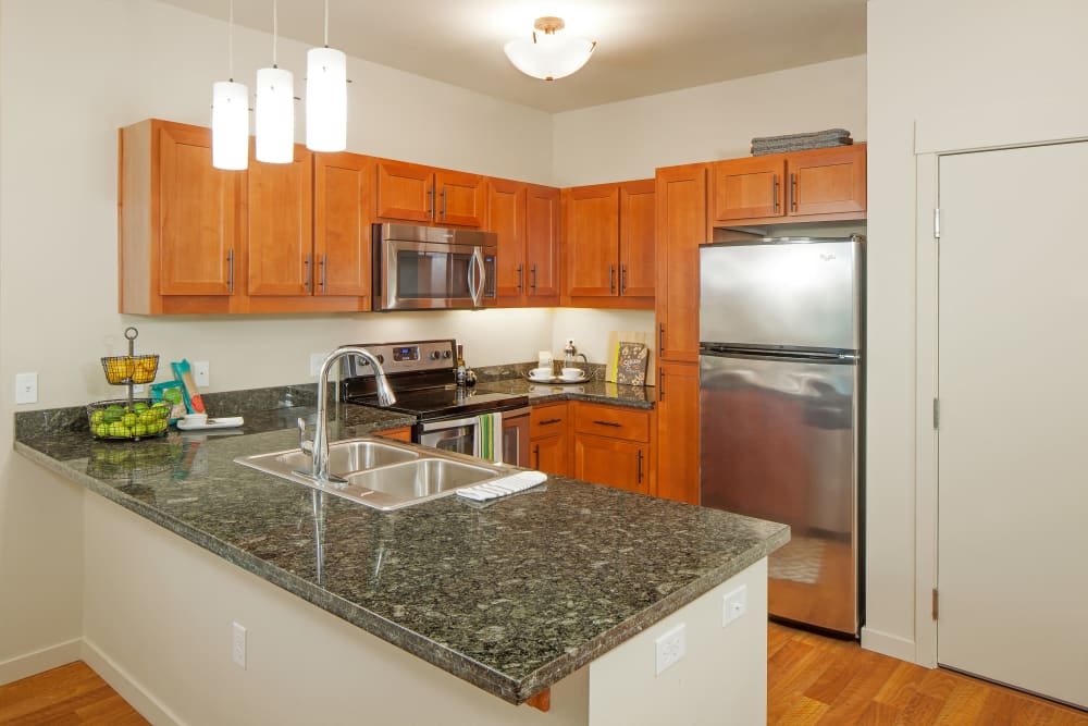 Apartment kitchen with stainless-steel appliances at Eddyline at Bridgeport in Portland, Oregon