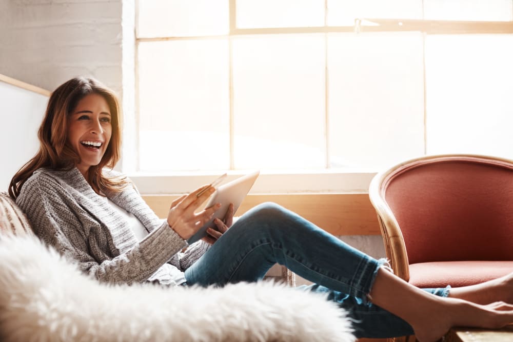Woman on her couch at Avilla Gateway in Phoenix, Arizona