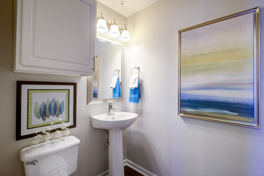 Bathroom with a mirror and bulb lights above to get ready with at The Quarry Townhomes in San Antonio, Texas