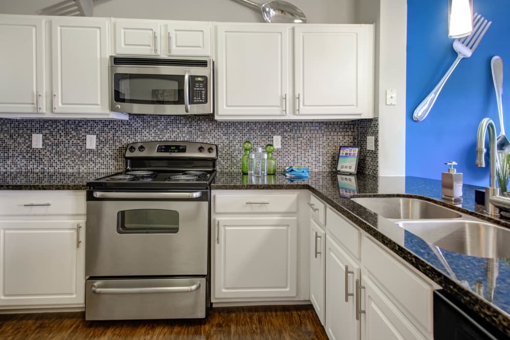 Kitchen with stainless steel appliances at The Quarry Townhomes in San Antonio, Texas