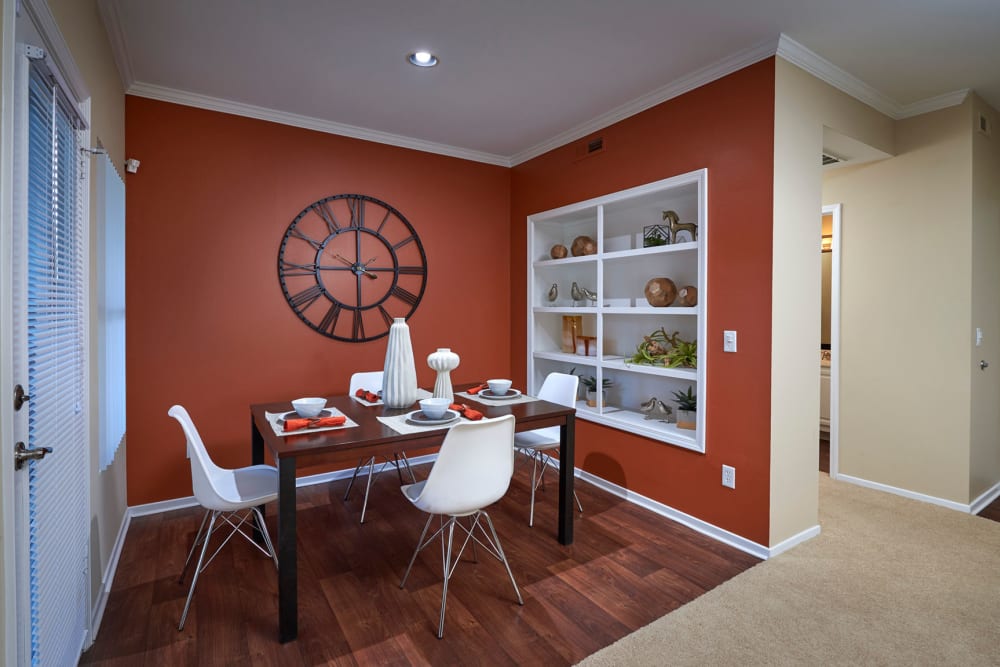 Dining room with wood-style flooring at Legend Oaks Apartments in Aurora, Colorado