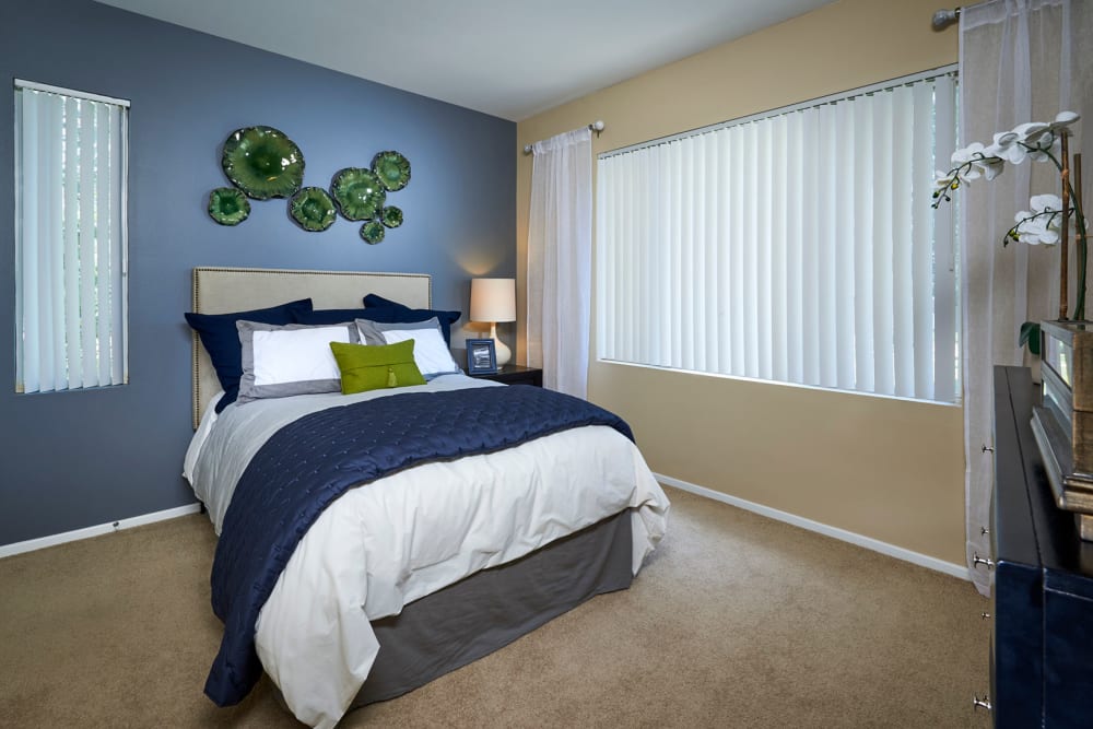 Master bedroom with a large window for natural lighting at Legend Oaks Apartments in Aurora, Colorado