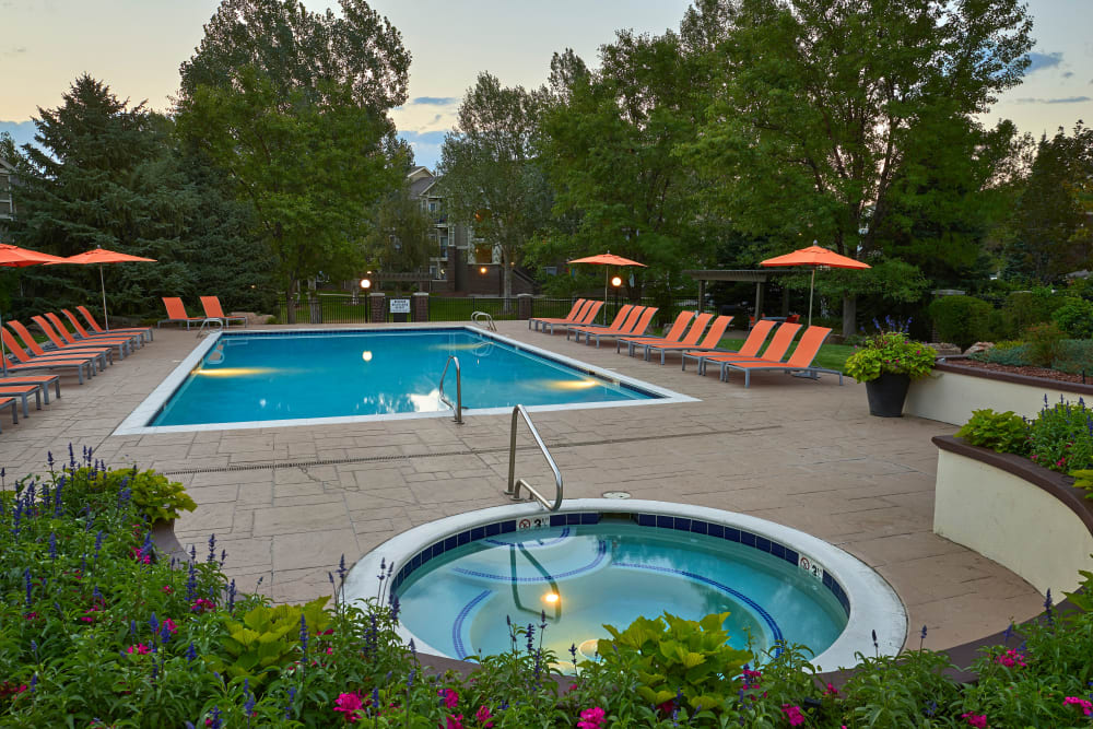 Swimming pool with a sundeck and lounge chairs at Legend Oaks Apartments in Aurora, Colorado